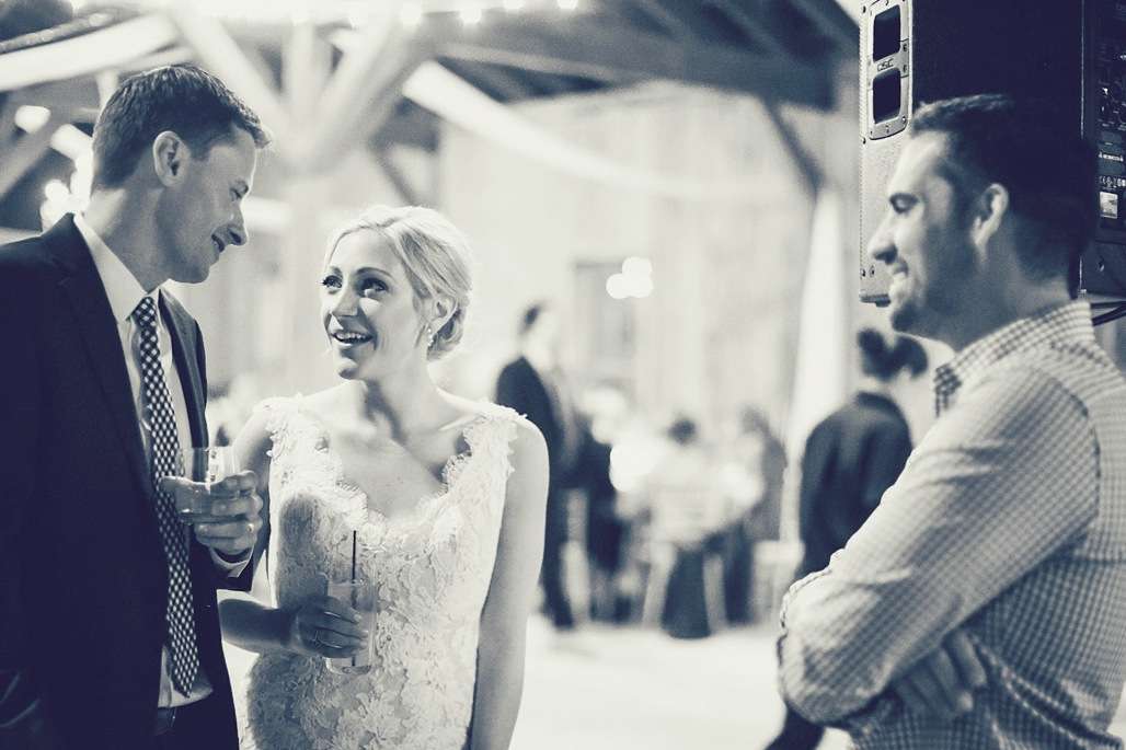 Bride dancing during an outdoor wedding reception while Stephen Darby performs nearby