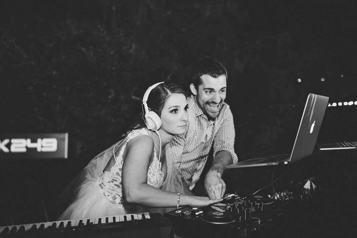 Bride wearing headphones while performing with Stephen Darby at the DJ and piano setup
