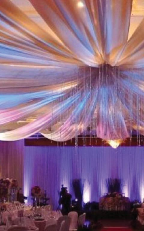 Elegant private celebration with draped ceiling and uplighting in Charleston.