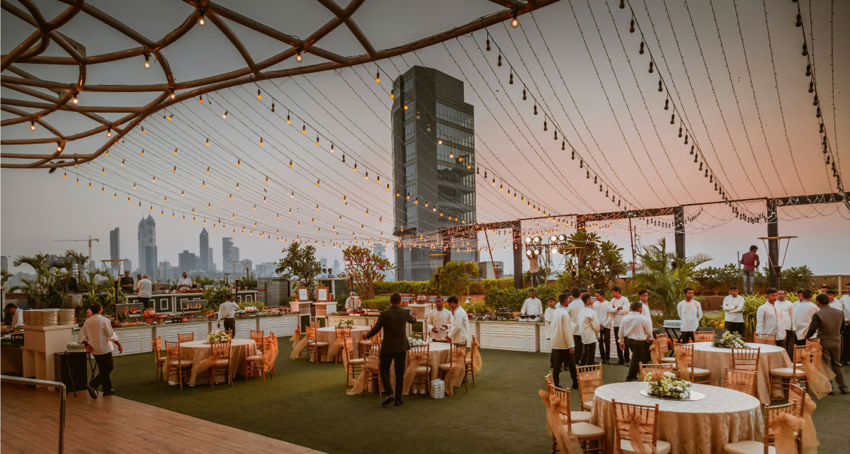Large-scale corporate celebration with stage lighting and crowd energy